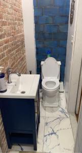 a bathroom with a toilet and a sink at Harlem Brownstone in New York