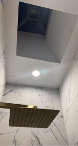 a ceiling in a bathroom with a marble counter top at Harlem Brownstone in New York