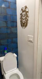 a bathroom with a toilet with a lion decal on the wall at Harlem Brownstone in New York