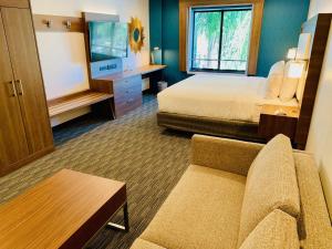 a hotel room with a bed and a couch at Holiday Inn Express Hollywood Walk of Fame by IHG in Los Angeles