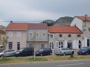 a group of cars parked in front of buildings at Kamena kuća-Stone house in Trebinje