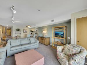 a living room with a couch and a chair at 111 Edgewater Inn in Charlevoix