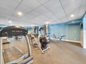 a gym with several tread machines in a room at 111 Edgewater Inn in Charlevoix