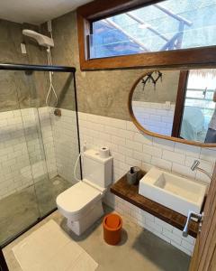 une salle de bain avec toilettes, lavabo et miroir dans l'établissement Casa Rústica com Rooftop e 2 Piscinas - 100mts do Mar - Rota dos Milagres, à São Miguel dos Milagres