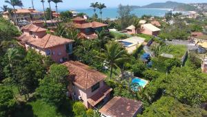 an aerial view of a house with trees and the ocean at Star Búzios Pousada in Búzios