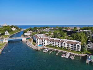 an aerial view of a marina with boats in the water at 119 Edgewater Inn in Charlevoix