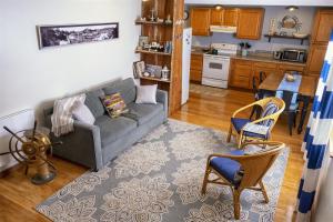 a living room with a couch and a kitchen at H - Salmon Run in Fort Bragg