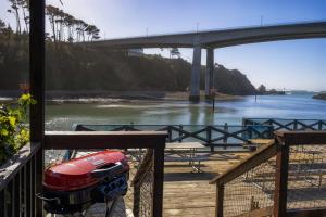 a view of a river with a bridge in the background at H - Harbor Watch in Fort Bragg