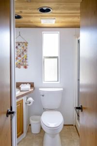 a bathroom with a white toilet and a window at H - Harbor Watch in Fort Bragg
