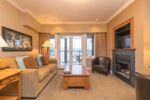 a living room with a couch and a fireplace at New Gorgeous Sidney Miraloma in Sidney