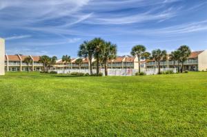 a large grassy field in front of a building at 10 A, One Bedroom Condo in Destin