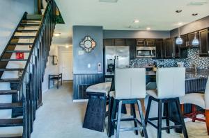 a kitchen and dining room with a bar and stairs at Seacove 7E 2 Bedroom Condo in Destin