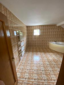 uma casa de banho vazia com uma banheira e um lavatório em Ramhouse em Piteşti