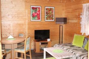 a living room with a couch and a table at Chata Leonka - Dolní Moravice in Dolní Moravice