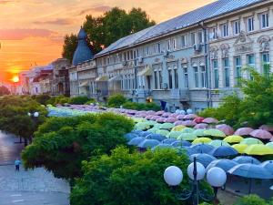 a large group of umbrellas in front of a building at Chira Chiralina Classic Apartment in Brăila +18 photos