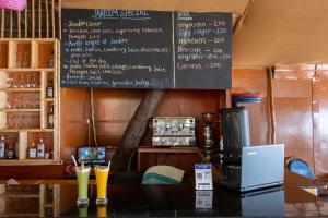 a restaurant with a chalkboard on the wall at Jardim a Mar in Agonda