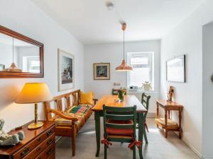 a dining room with a table and chairs and a couch at Tranquil Pepelow Retreat in Pepelow +32 photos