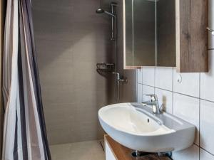 a white bathroom with a sink and a shower at Tranquil Pepelow Retreat in Pepelow