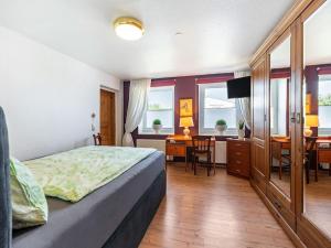 a bedroom with a bed and a desk and a table at Tranquil Pepelow Retreat in Pepelow