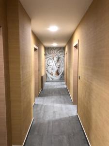a hallway with a mural of a lion on the wall at APARTHOTEL BON BON in Sofia