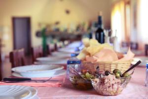 a table with plates and bowls of food on it at Agriturismo Il Ginepro in Fluminimaggiore