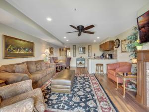 a living room with a couch and a table at 238 Edgewater Inn in Charlevoix