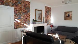 a living room with a couch and a fireplace at Arsonval in Saint-Junien