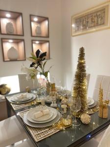 a dining room table with christmas decorations and a christmas tree at Sea Elegance in Oliveri