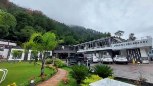 a group of cars parked in a parking lot in front of a building at Cordillera Resort in Hassa