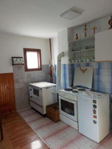 a small kitchen with a stove and a sink at Domaćinstvo Sindžirević in Nova Varoš