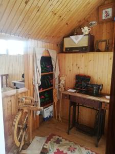 a small room with a table and a stove at Domaćinstvo Sindžirević in Nova Varoš +4 photos