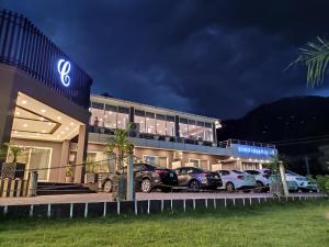 a building with cars parked outside of it at night at Cordillera Resort in Hassa