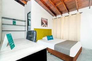Postel nebo postele na pokoji v ubytování Ayenda Casa San Pablo