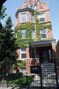 a tall brick building with ivy growing on it at Sunny, Spacious, 3BR 1BA Davlin INN Chicago in Chicago