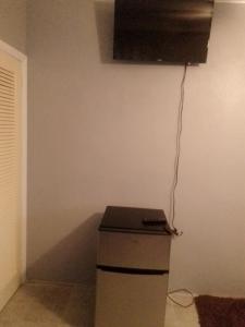 a corner of a room with a counter and a television at Errol and Nancy Place in Nassau