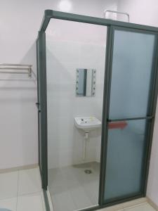 ein Bad mit einer Glasdusche und einem Waschbecken in der Unterkunft Sekinchan 71 Landed PaddyView House 16pax Wifi in Kampong Sungai Leman