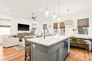 a kitchen with a sink and a living room at Family Tides in Santa Rosa Beach