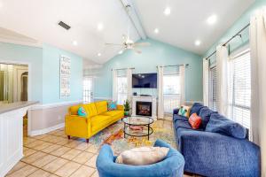 a living room with two blue couches and a yellow couch at Ripplin Sands in Dauphin Island