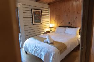 a bedroom with a bed with a towel on it at Glenaire Cottages in Glenaire