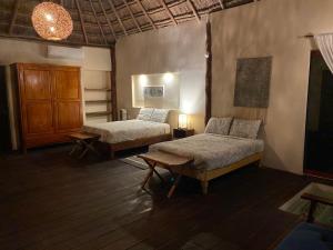 En eller flere senge i et værelse på Xoot Ka’Ana Villa Sensación