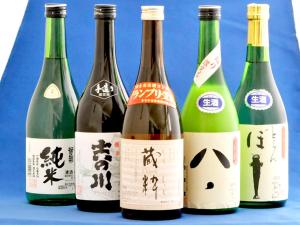 a group of four bottles of wine on a table at Pension Buddy in Kitashiobara