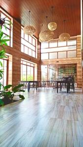 a large room with tables and chairs and windows at The Piccolo Hotel of Boracay in Boracay