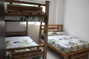 a bedroom with two bunk beds and a window at Mar y Tierra in Coveñas