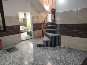 a lobby with a staircase and a mirror at Vidya Guest House in Katra