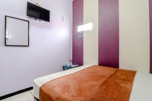 Hotel Bintang tesisinde bir odada yatak veya yataklar