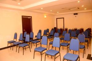 a room with a bunch of chairs and a podium at HOTEL SAHARA SDN BHD in Rawang