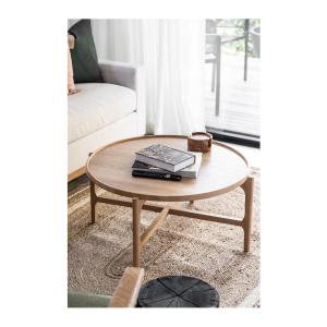 a coffee table with books on it next to a couch at Modern Studio with Outdoor Bath and Cabin Sauna in Albion Park