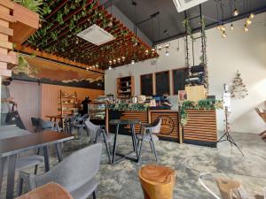 a restaurant with tables and chairs in a room at Hotel 17 in Kota Kinabalu