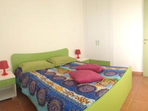 a bedroom with a bed with pillows on it at Pitagora Residence in Metaponto