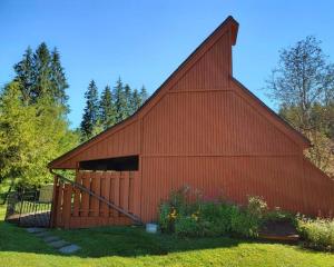 a red barn with a large gambrel at The Davis Loft in Davis